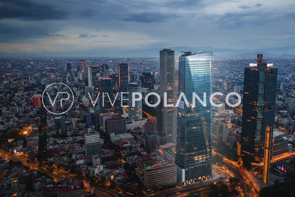 Aerial view of modern skyscrapers in Mexico City's business district at dusk.