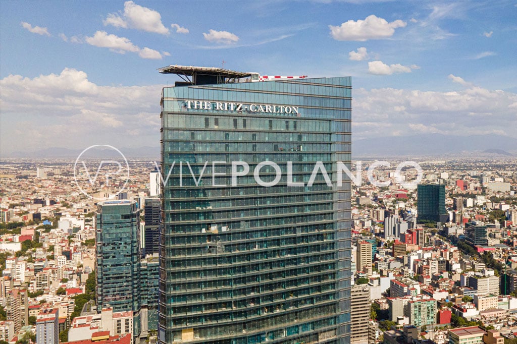 Aerial view of a modern high-rise building in an urban landscape showcasing the Ritz-Carlton luxury condominium