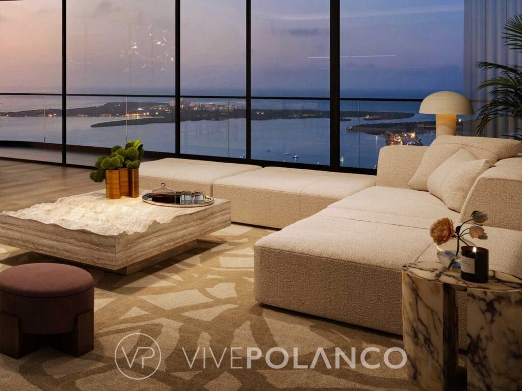 Sala de estar de Mercedes-Benz Places con sofá beige, mesa de mármol y ventanales con vista nocturna a Miami en Mercedes Benz Condo Miami, Polanco