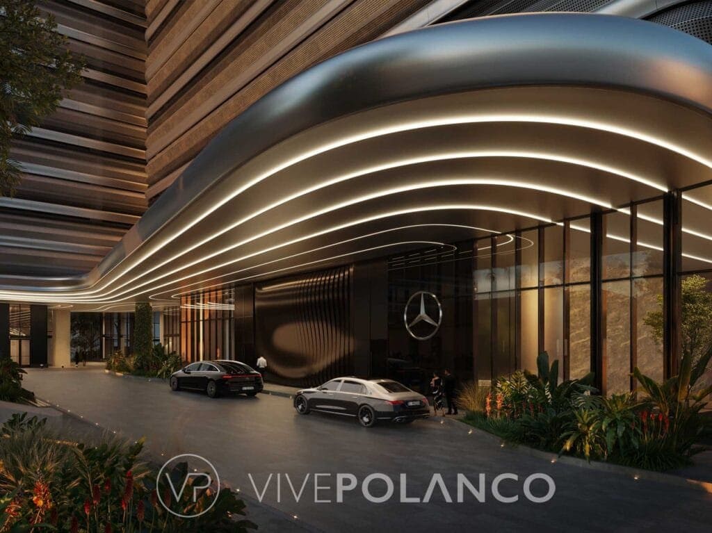Entrada vehicular de Mercedes-Benz Places en Miami con techo curvo iluminado y vehículos de lujo en Mercedes Benz Condo Miami, Polanco