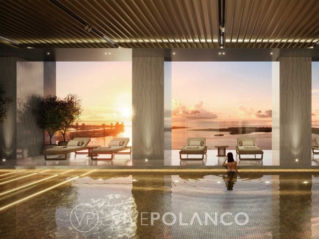 Área de piscina del 888 Brickell Miami con mobiliario de lujo y vista panorámica al atardecer sobre la bahía