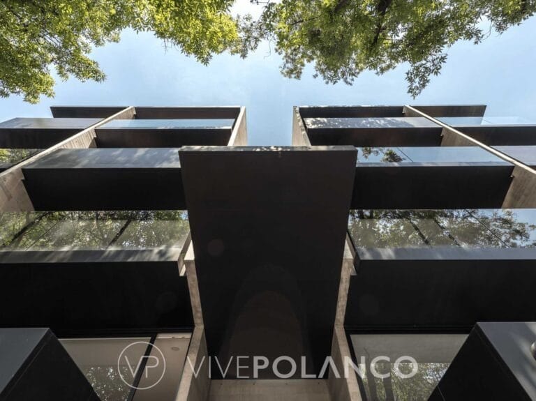 Vista inferior de fachada de edificio moderno con balcones escalonados y elementos de concreto contemporáneos en Sudermann, Polanco